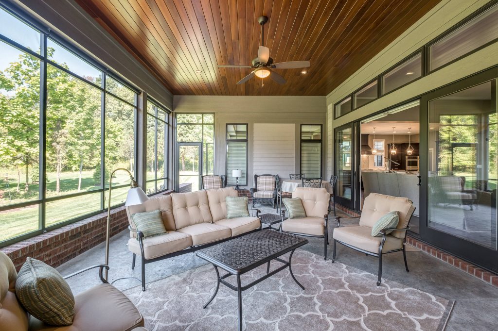 This is an example of a traditional screened-in porch design in Other with a roof extension. by G.A. White Homes | Outdoor Photos | Porch | Landscaping | Landscape Design | Outdoor Living Space | Porch Design Ideas | Outdoor Living Space Ideas | Backyard Design