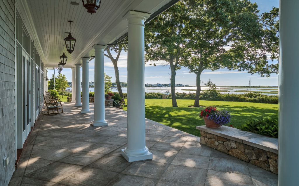 This is an example of a traditional side porch design in Boston with a roof extension. by GIBSON SOTHEBY’S INTERNATIONAL REALTY | Outdoor Photos | Porch | Landscaping | Landscape Design | Outdoor Living Space | Porch Design Ideas | Outdoor Living Space Ideas | Backyard Design