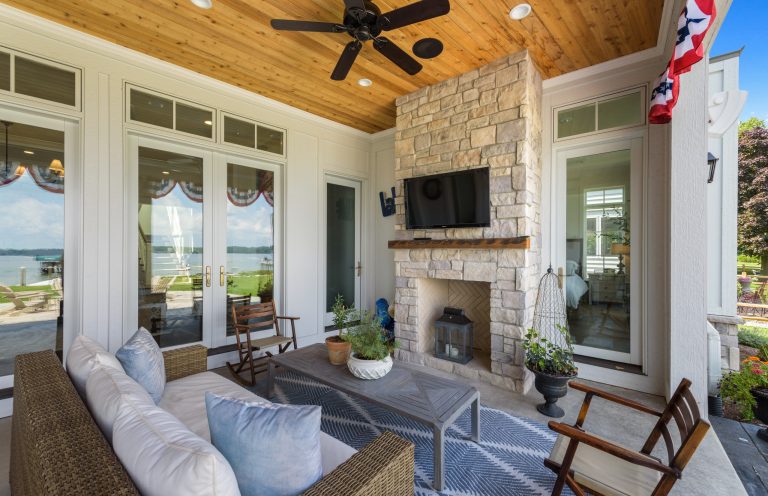 This is an example of a traditional stone back porch design in Indianapolis with a fireplace and a roof extension. by Carr Warner, Architects | Outdoor Photos | Porch | Landscaping | Landscape Design | Outdoor Living Space | Porch Design Ideas | Outdoor Living Space Ideas | Backyard Design