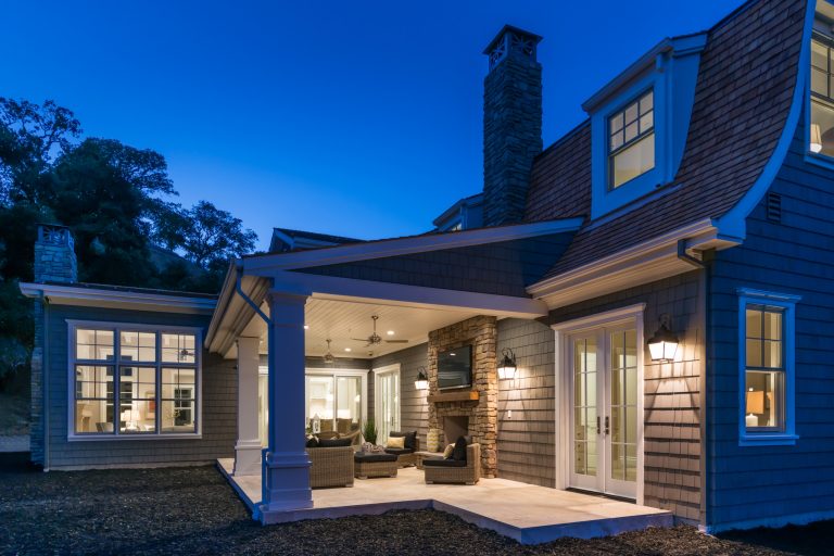 This is an example of a traditional stone back porch design in San Francisco with a fire pit and a roof extension. by The ADDRESS Company | Outdoor Photos | Porch | Landscaping | Landscape Design | Outdoor Living Space | Porch Design Ideas | Outdoor Living Space Ideas | Backyard Design