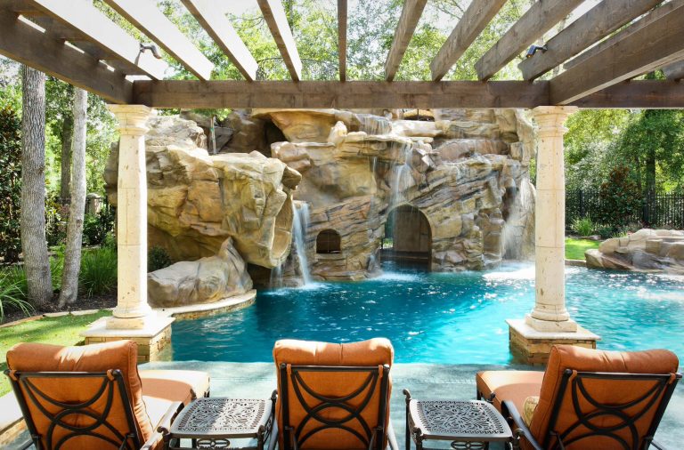 This is the natural lagoon free form side of the space, with a full swim in grotto, 28' slide, swim up bar, tv, pop corn, and snow cone machine inside the grotto for the kids to grab a refreshment