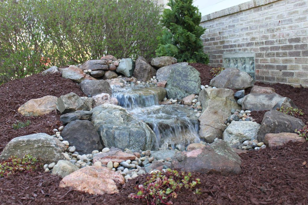 This is the picture of one of our medium pondless waterfalls in Dexter,MI. It is all self contained and makes a beautiful accent to any back or front yard landscape. Photo by Cory Mann