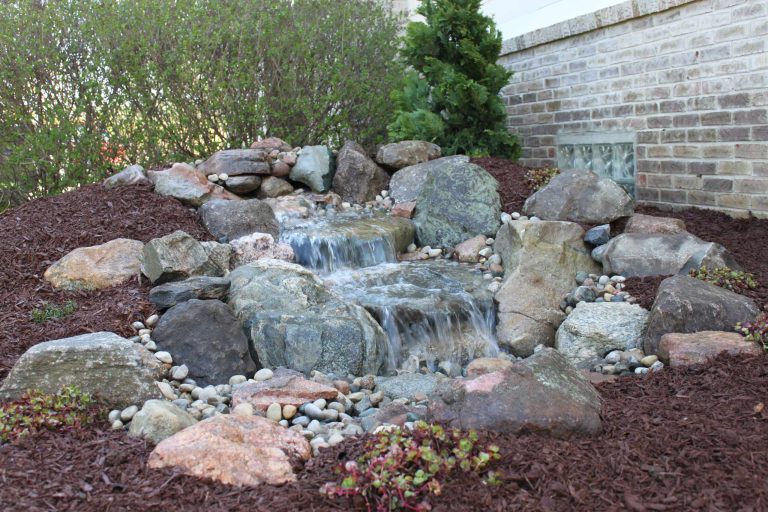 This is the picture of one of our medium pondless waterfalls in Dexter,MI. It is all self contained and makes a beautiful accent to any back or front yard landscape. Photo by Cory Mann