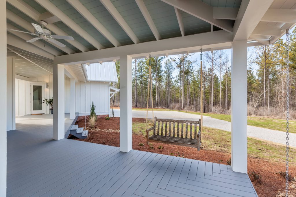 This large front porch connects the house to the garage and provides a place to relax. PVC columns and beams for durability and low maintenance. Rain chains, bench swing. Inspiro 8 by CarsonSpeer Builders | Outdoor Photos | Porch | Landscaping | Landscape Design | Outdoor Living Space | Porch Design Ideas | Outdoor Living Space Ideas | Backyard Design