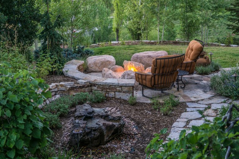 This natural gas fire pit built from natural boulders offers year round functionality. The bubbling rock water feature adds to the ambiance, providing the tranquil sound of a natural creek. by Accent Landscapes | Backyard Design | Outdoor Living Spaces | Landscape Design | Backyard Ideas | Landscaping | Landscaping Ideas | Landscape Installation