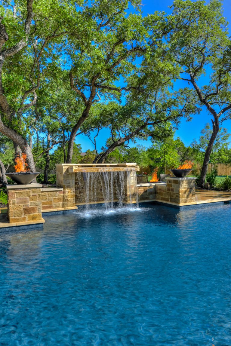 This pool has a large waterfall with grotto and two fire bowls. Photographer: Siggi Ragnar
