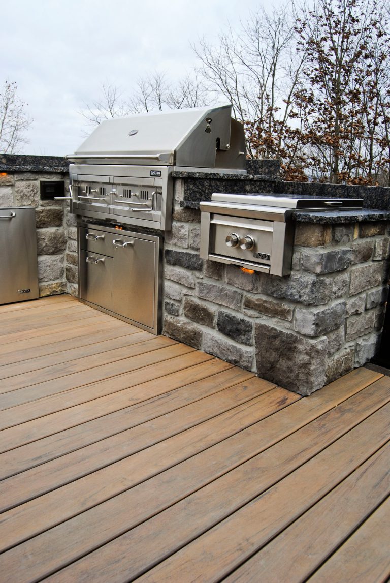 This project was defiantly designed with entertaining in mind. With it's top of the line kitchen and built in fire pit , this space has room for everyone. Photography By: Keystone Custom Decks