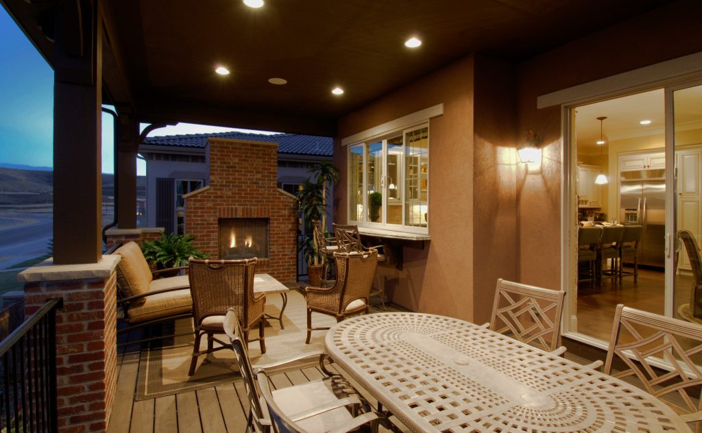 This rear, covered deck with a pass through bar from the kitchen is a great space to have a backyard party.