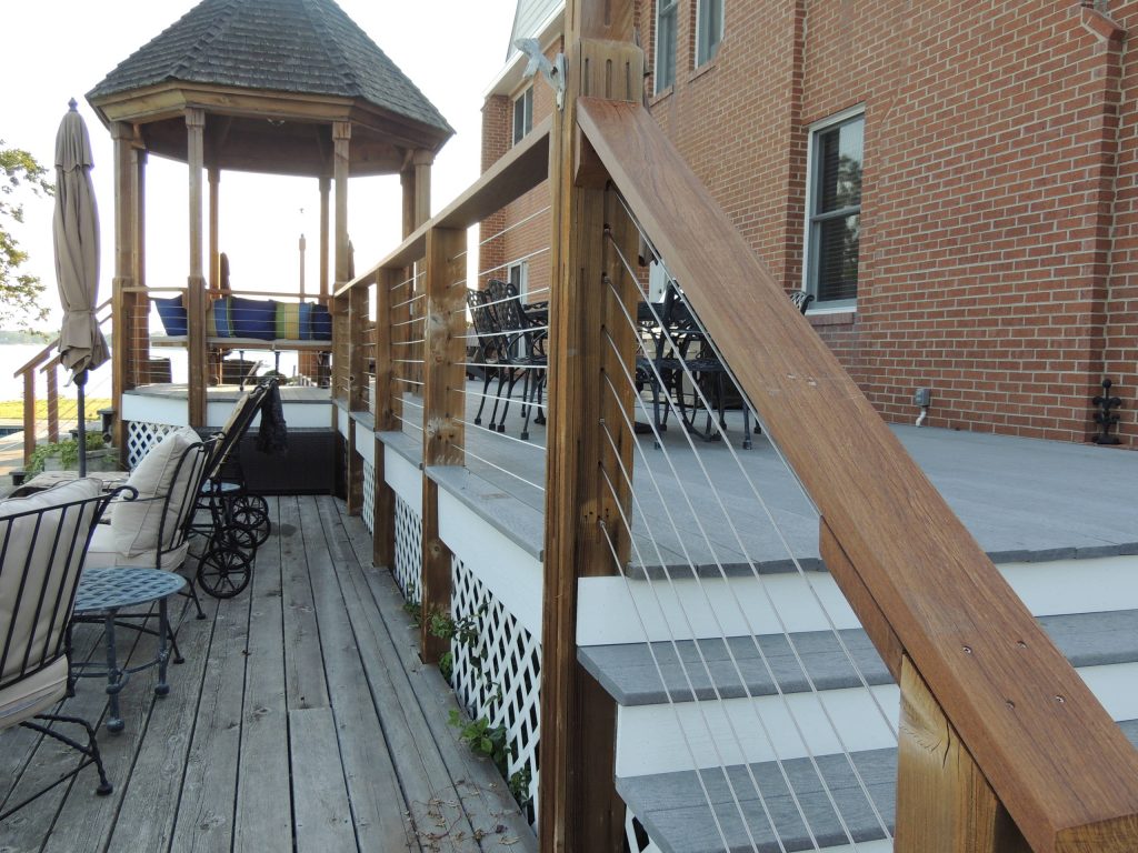 This stately residence in Lusby MD creatively utilizes modern, rustic, and playful features to enhance it's regal presence. Wood Post, Rail, and supports, with Stainless steel cable railing and end fittings.