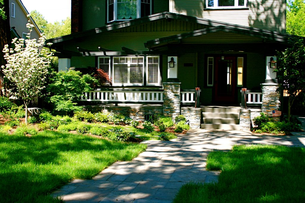 This woodland garden creates an inviting welcome to this Craftsman style porch.