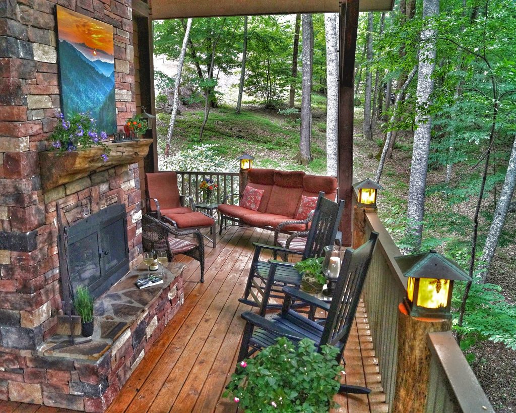 Timber Framed Covered porch with outdoor fireplace. So serene with the sounds of the stream.