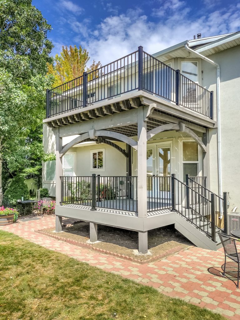 Timber frame double deck kit replaces a wood deck for backyard entryway.