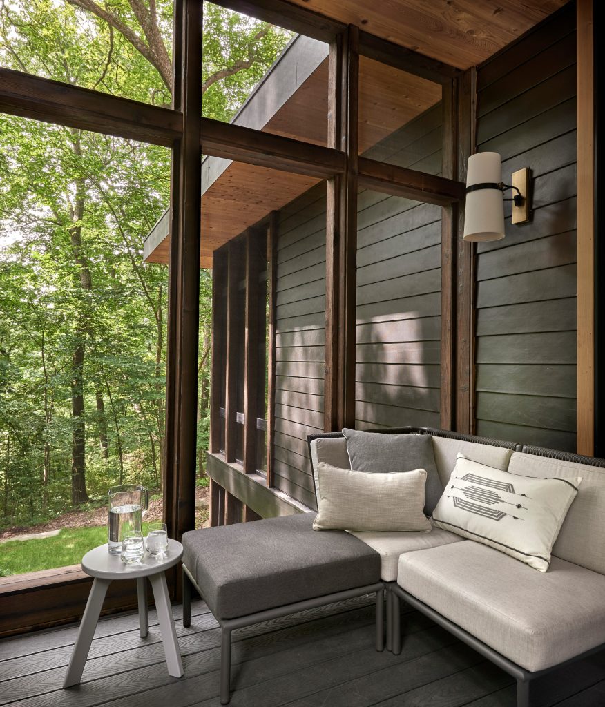 To avoid blocking views from interior spaces, this porch was set to the side of the kitchen. Telescoping sliding doors create a seamless connection between inside and out. by Searl Lamaster Howe Architects | Outdoor Photos | Porch | Landscaping | Landscape Design | Outdoor Living Space | Porch Design Ideas | Outdoor Living Space Ideas | Backyard Design