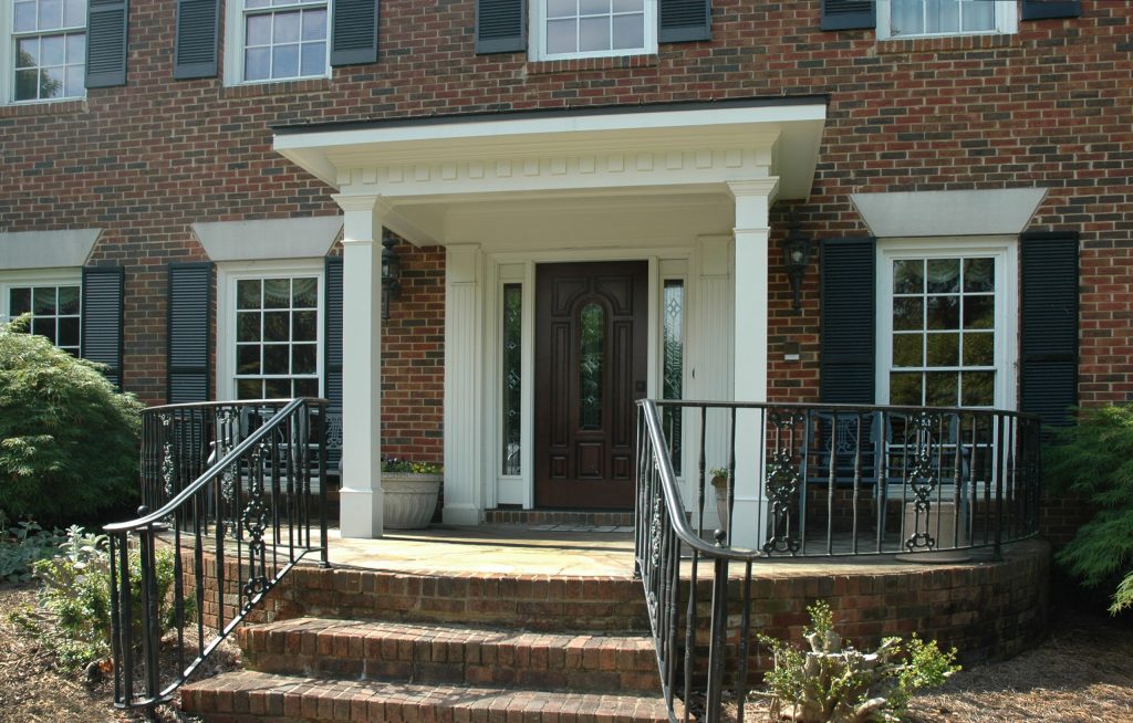 Traditional 2 column shed roof portico with curved railing. Designed and built by Georgia Front Porch.