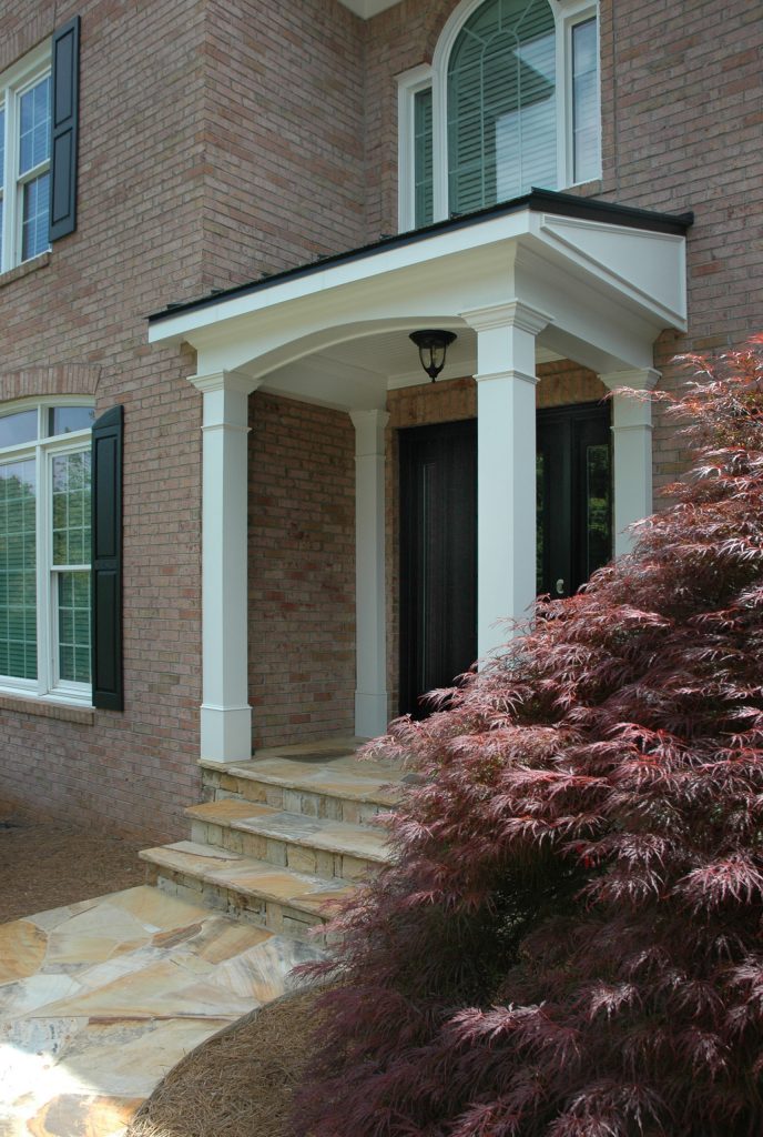 Traditional 2 column shed roof portico with curved railing. Designed and built by Georgia Front Porch.