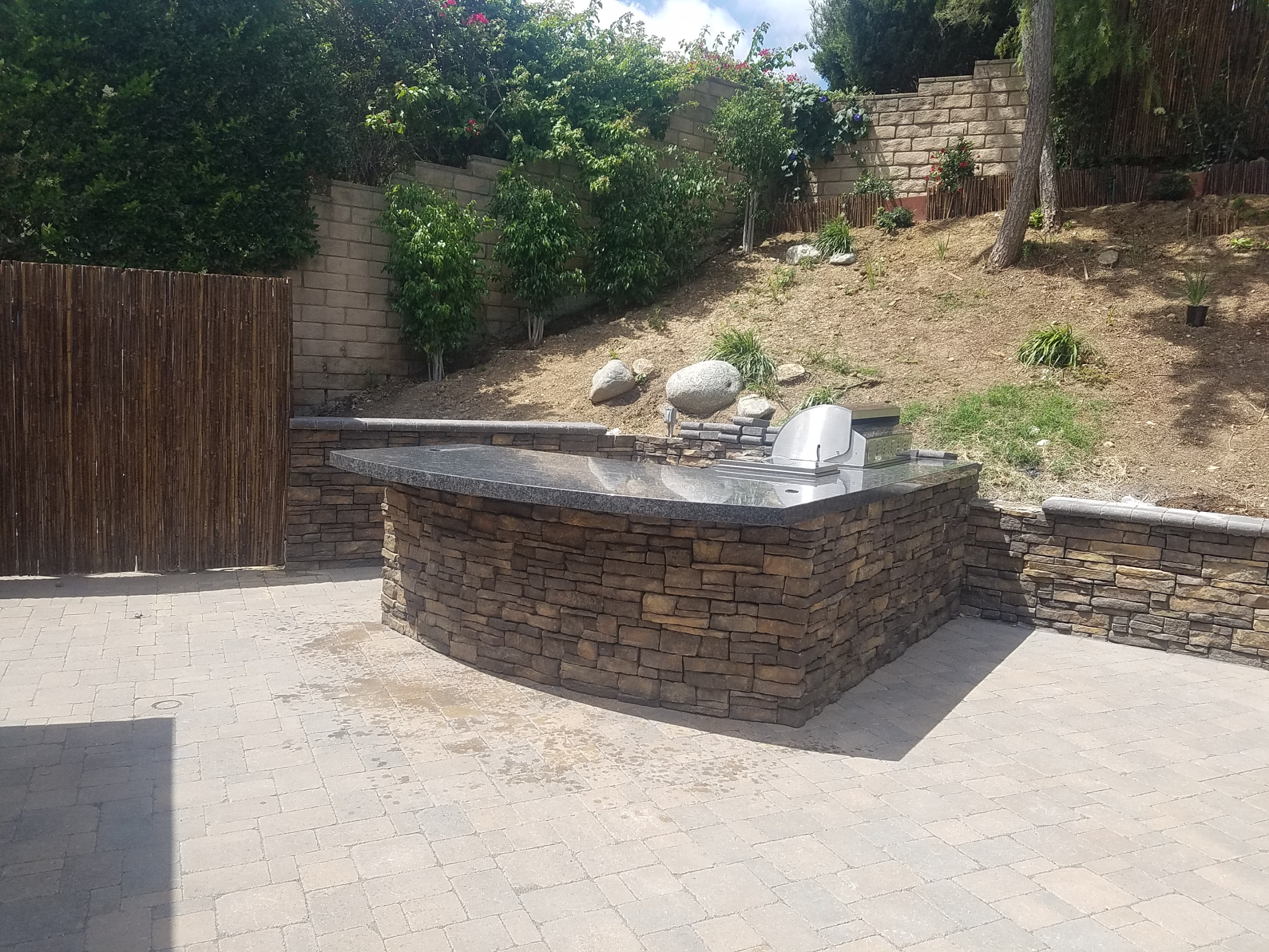 Traditional L-shaped Island with stone walls
Patio kitchen – traditional backyard patio kitchen idea in Los Angeles