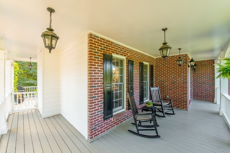 Traditional brick home with wrap around porch in Chattahoochee River Club - Cumming GA