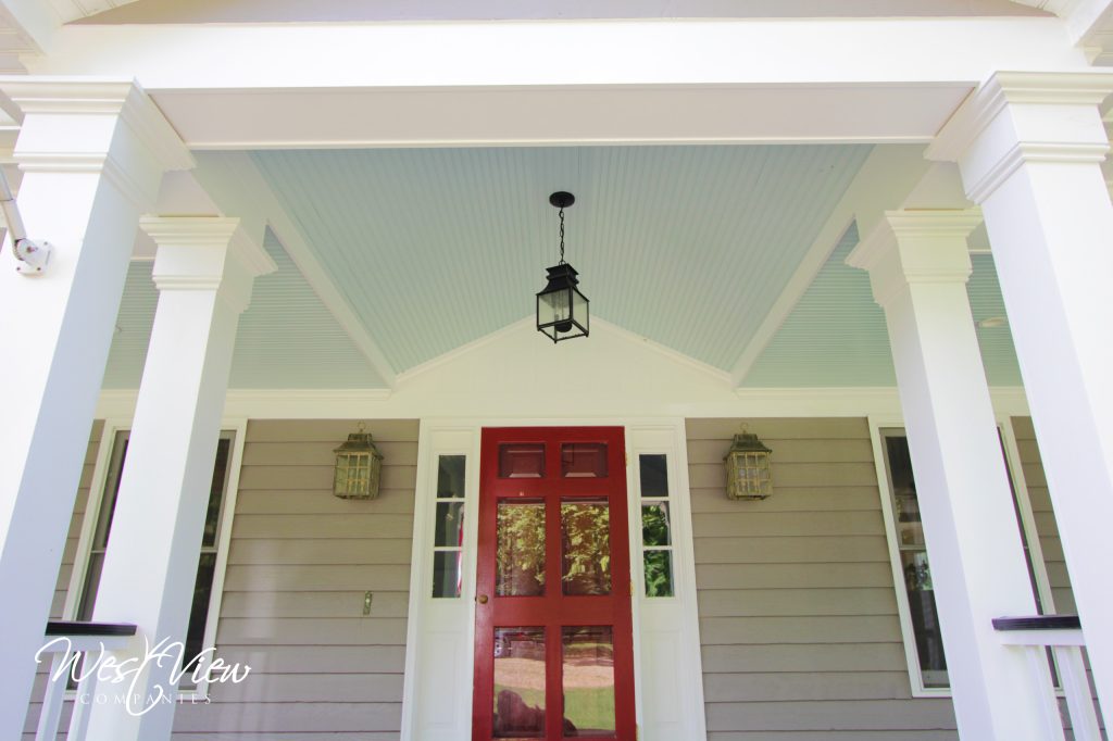 Traditional porch with updated railing, beadboard ceiling. Ceiling was vaulted in front of the front door.