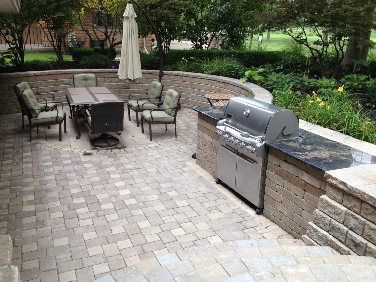 Transitional backyard brick patio kitchen photo in Detroit