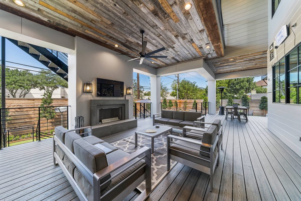 Transitional backyard deck photo in Houston with a fireplace and a roof extension