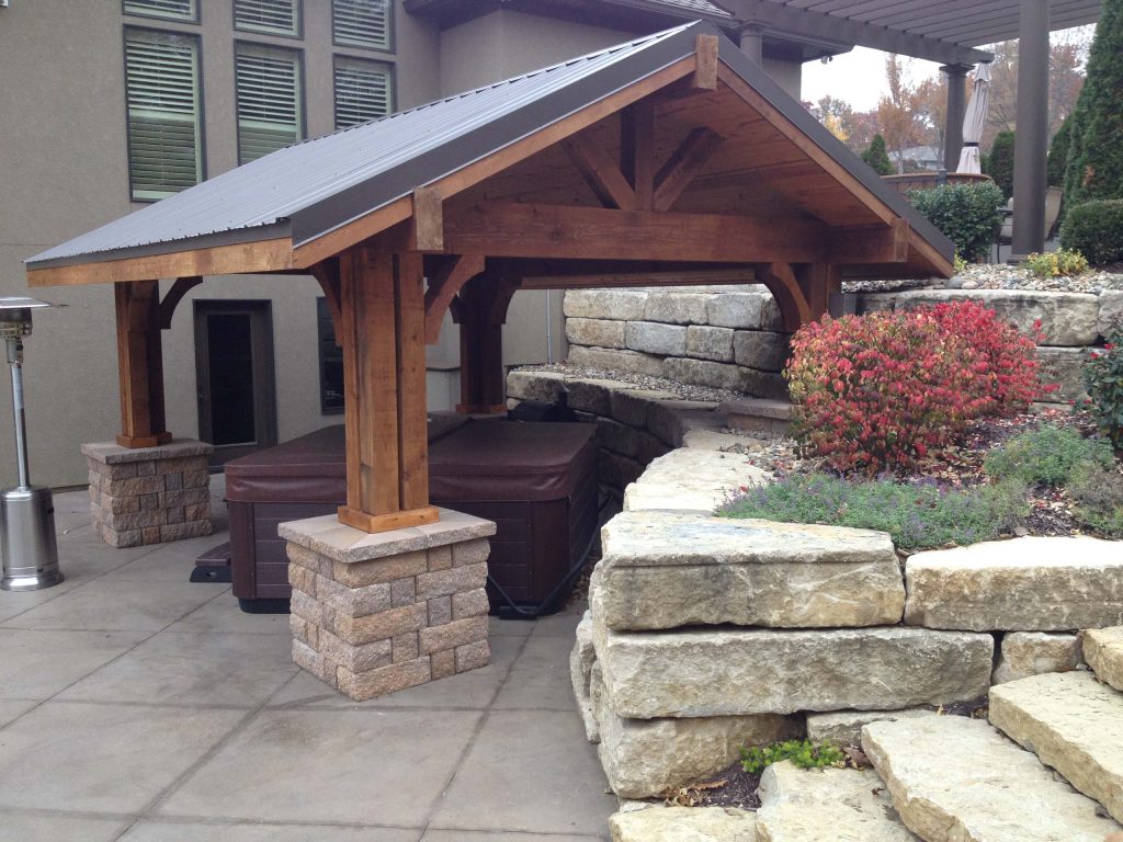Transitional concrete patio kitchen photo in Kansas City with a gazebo
