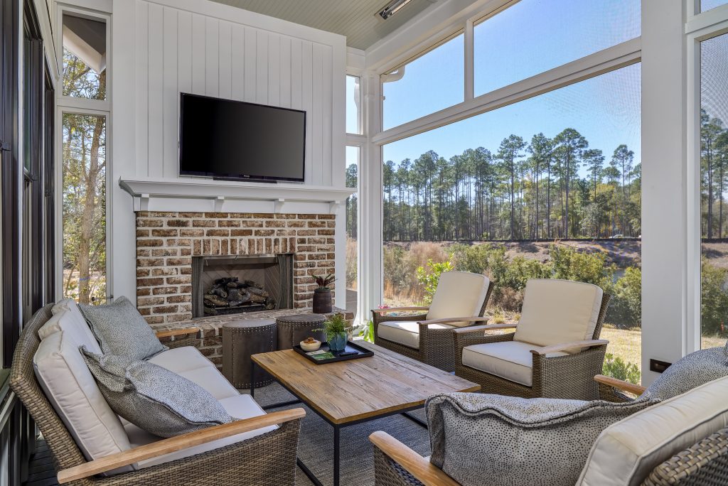 Transitional porch photo in Atlanta with a fireplace, decking and a roof extension by Coastal Signature Homes | Outdoor Photos | Porch | Landscaping | Landscape Design | Outdoor Living Space | Porch Design Ideas | Outdoor Living Space Ideas | Backyard Design