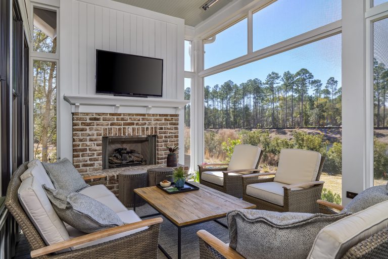 Transitional porch photo in Atlanta with a fireplace, decking and a roof extension by Coastal Signature Homes | Outdoor Photos | Porch | Landscaping | Landscape Design | Outdoor Living Space | Porch Design Ideas | Outdoor Living Space Ideas | Backyard Design