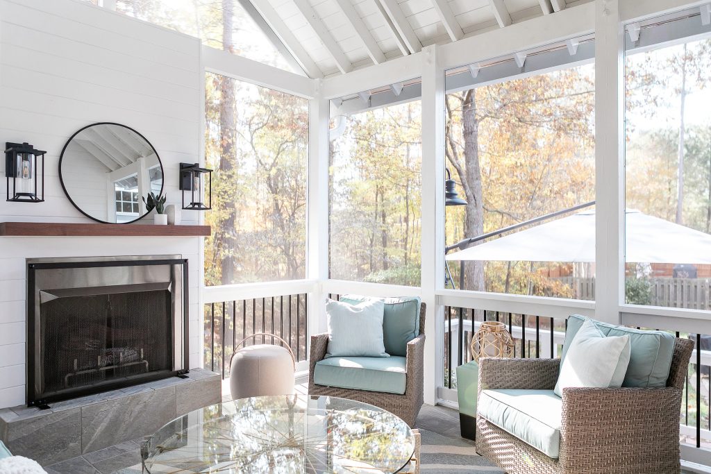 Transitional stone wood railing porch photo in Raleigh with a fireplace and a roof extension by Catherine French Design, LLC. | Outdoor Photos | Porch | Landscaping | Landscape Design | Outdoor Living Space | Porch Design Ideas | Outdoor Living Space Ideas | Backyard Design
