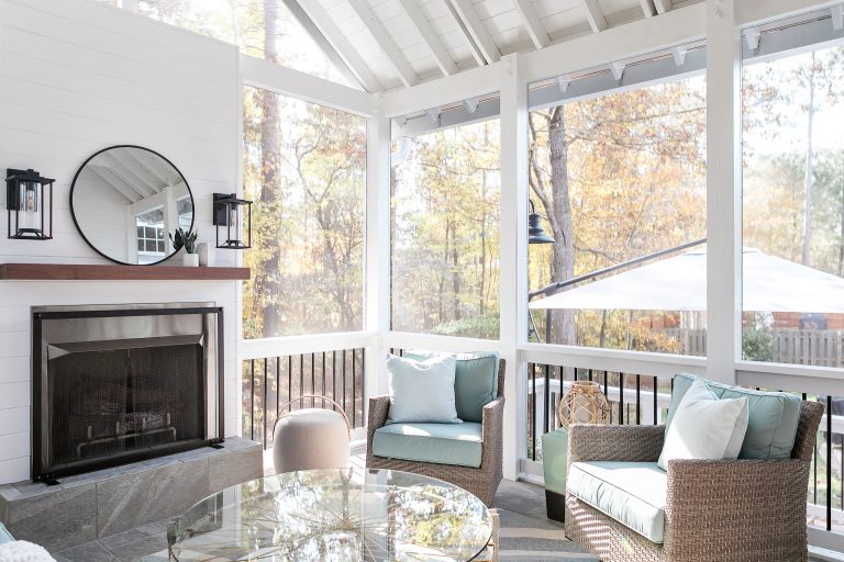 Transitional stone wood railing porch photo in Raleigh with a fireplace and a roof extension by Catherine French Design, LLC. | Outdoor Photos | Porch | Landscaping | Landscape Design | Outdoor Living Space | Porch Design Ideas | Outdoor Living Space Ideas | Backyard Design