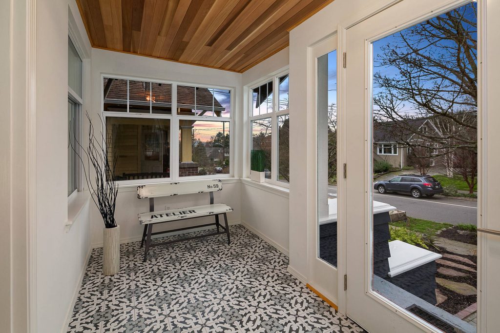 Transitional tile screened-in front porch idea in Seattle with a roof extension by Home Docket | Windermere Real Estate Co. | Outdoor Photos | Porch | Landscaping | Landscape Design | Outdoor Living Space | Porch Design Ideas | Outdoor Living Space Ideas | Backyard Design