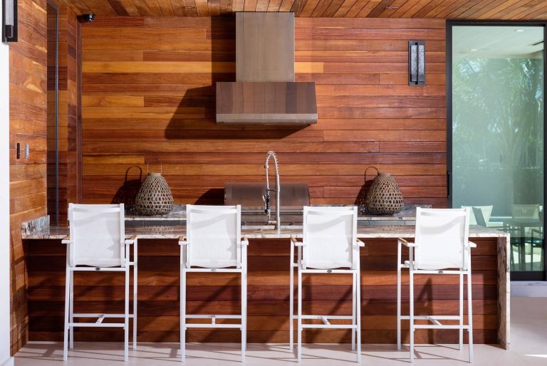 Trendy backyard patio kitchen photo in Miami with a roof extension