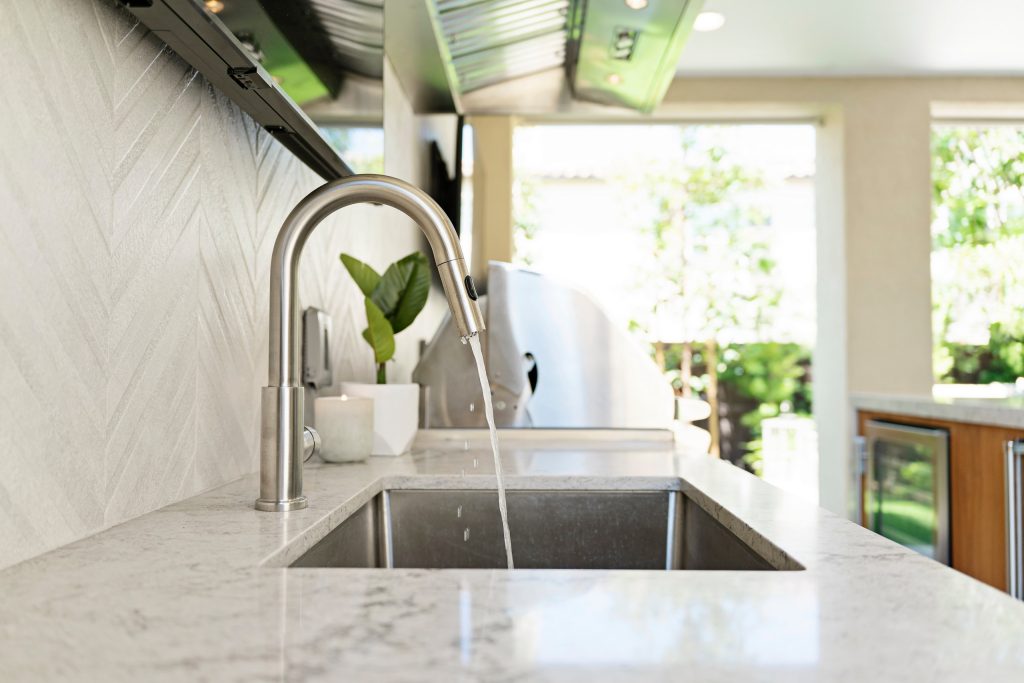 Trendy backyard patio kitchen photo in San Diego with a roof extension
