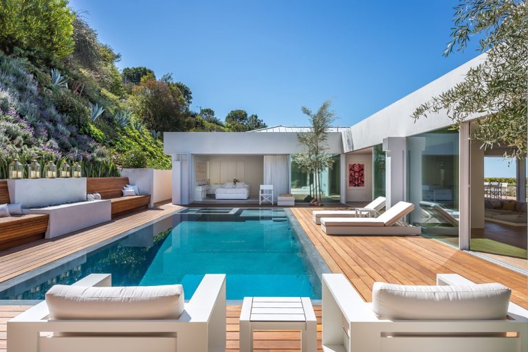 Trendy backyard rectangular infinity hot tub photo in Los Angeles with decking