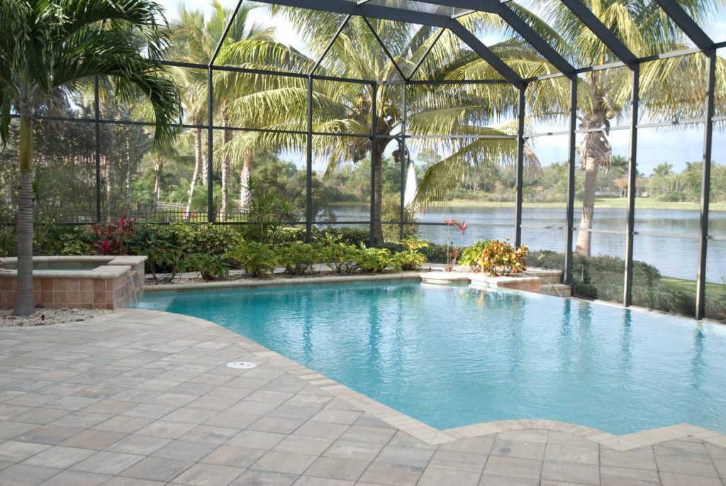 Tropical Infinity Pool with jacuzzi and screen enclosure