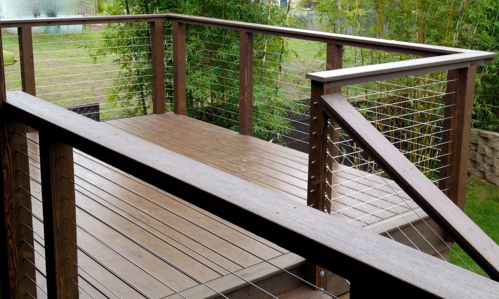 Turning corners with cable. Rough sawn wood posts with PVC top railings. Complete wooden kits available. Steve Sherritt--San Diego Cable Railings