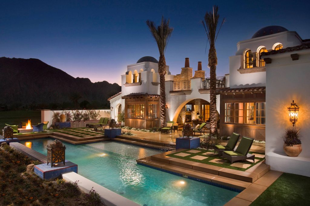 Tuscan backyard concrete and custom-shaped lap pool fountain photo in Orange County