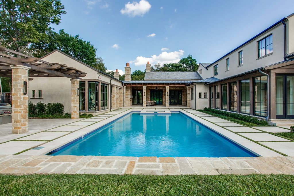 Tuscan courtyard rectangular hot tub photo in Dallas