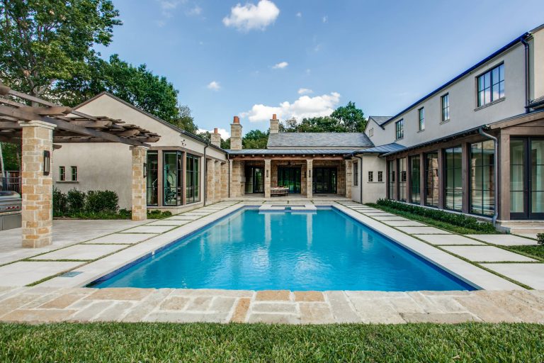 Tuscan courtyard rectangular hot tub photo in Dallas