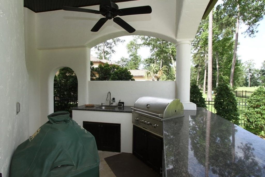 Tuscan patio kitchen photo in Houston