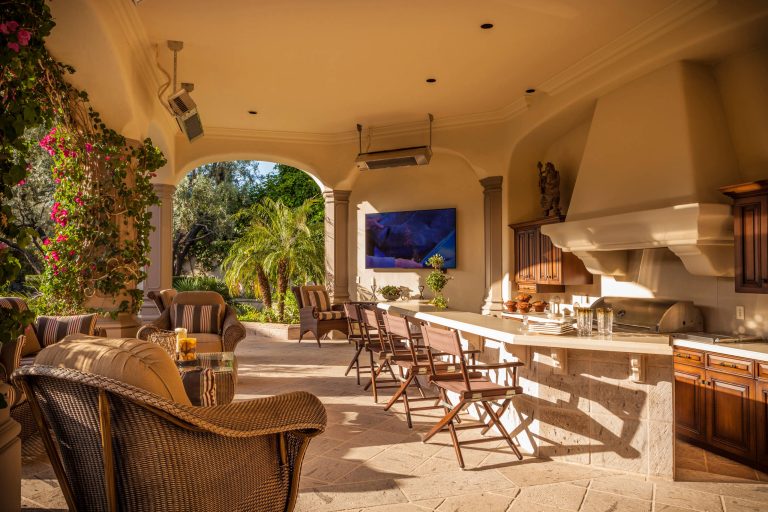 Tuscan patio kitchen photo in Phoenix with a roof extension