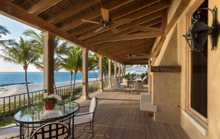 Tuscan porch photo in Miami with a fire pit, decking and a roof extension by O'Guin Decorative Finishes | Outdoor Photos | Porch | Landscaping | Landscape Design | Outdoor Living Space | Porch Design Ideas | Outdoor Living Space Ideas | Backyard Design