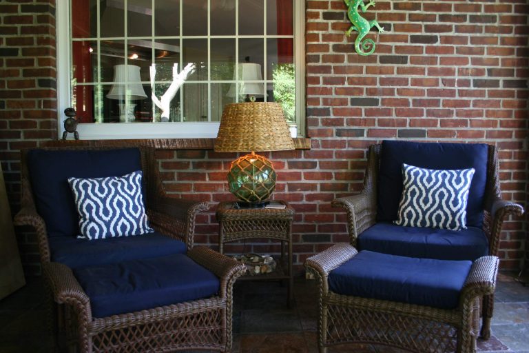 Unique vintage fishing float made into a dramatic lamp with a sea-grass lampshade for this comfortable lounging porch.