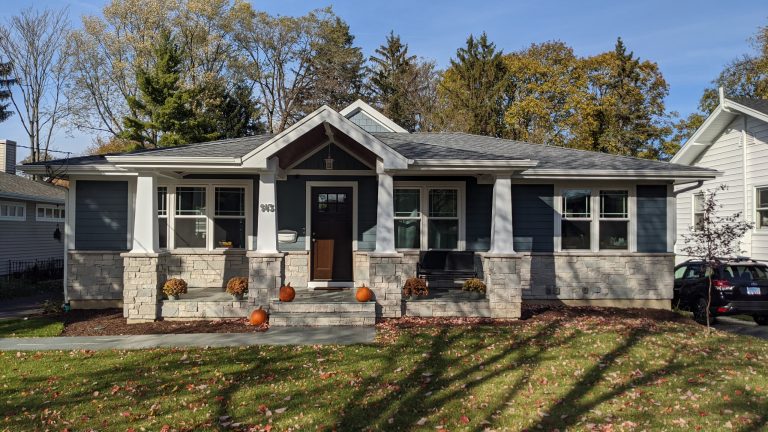 View of new front porch. Owner used a large format stone for the porch surface. Gable of the great room addition visible beyond. All windows and siding are new. by Berneche2 Architecture PC | Outdoor Photos | Porch | Landscaping | Landscape Design | Outdoor Living Space | Porch Design Ideas | Outdoor Living Space Ideas | Backyard Design