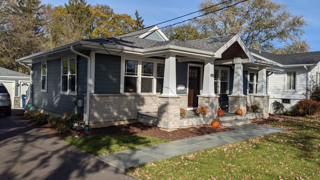 View of new front porch looking toward the back yard and existing freestanding garage.