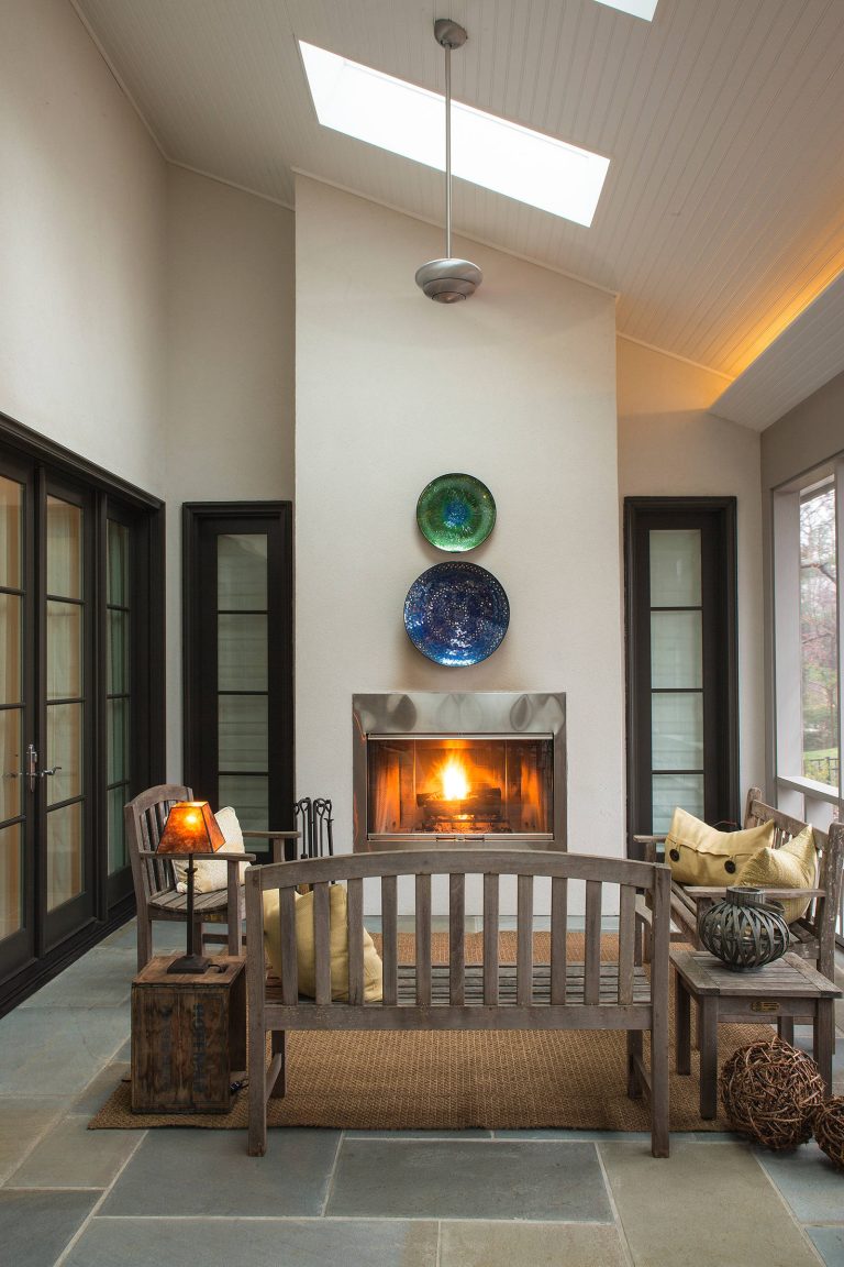Warm and welcoming outdoor living space with screened wall, outdoor fireplace, blue slate tile, tall ceilings, outdoor ceiling fans, stucco exterior walls which all open to the interior great room. by Johker Design | Outdoor Photos | Porch | Landscaping | Landscape Design | Outdoor Living Space | Porch Design Ideas | Outdoor Living Space Ideas | Backyard Design