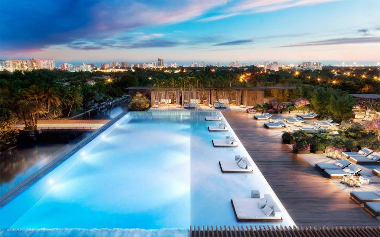 Water slide - large modern rooftop custom-shaped lap water slide idea in Miami with decking