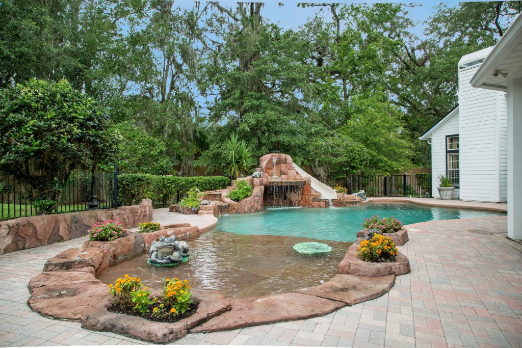 Water slide - traditional stone and custom-shaped water slide idea in Jacksonville
