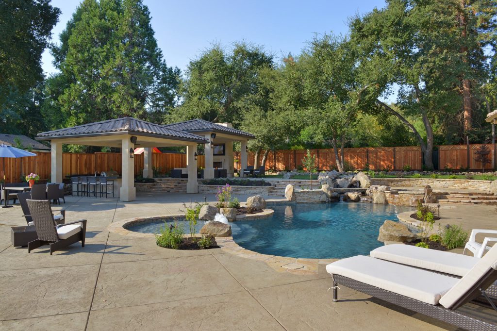 This back yard is full of micro environments for every type of entertainment, Pool/Spa/Waterfall, BBQ, Bar, Fireplace and outdoor TV
