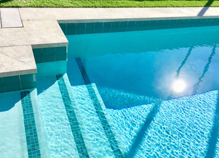 Waterline tile with iridescent accents add extra beauty and shine.