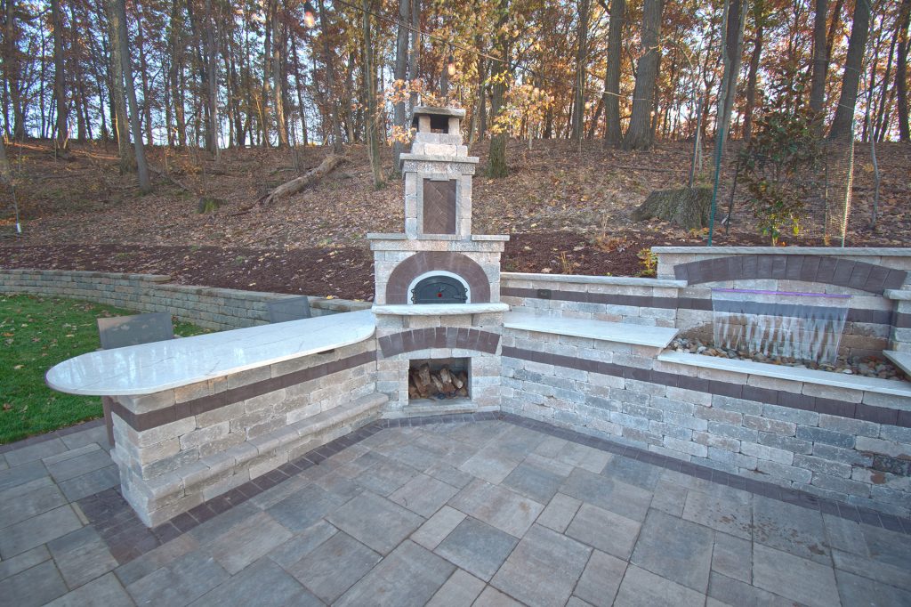We installed a large Chicago brick oven using Unilock Brussels river blend with El Campo Mocha accents for the masonry work (pizza oven, bar and oversized fireplace).
